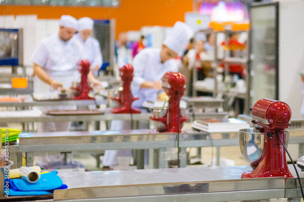 Professional chef, baker workplace with modern kitchen stand food mixers on tables at cuisine of restaurant, bakery. Cooking, catering, culinary, gastronomy and food concept Professional chef, baker workplace with modern kitchen stand food mixers on tables at cuisine of restaurant, bakery. Cooking, catering, culinary, gastronomy and food concept