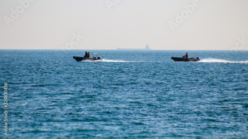 two motor military boats in the open sea © AlexR