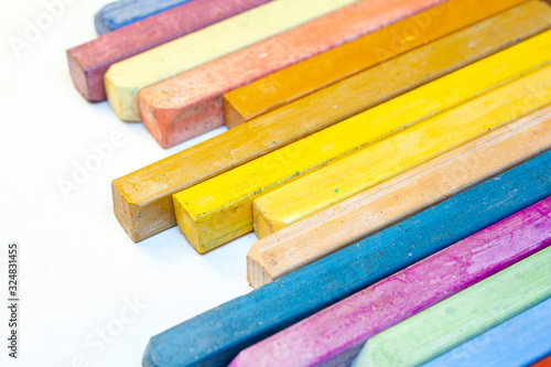 Close up shot of colorful crayons on white background