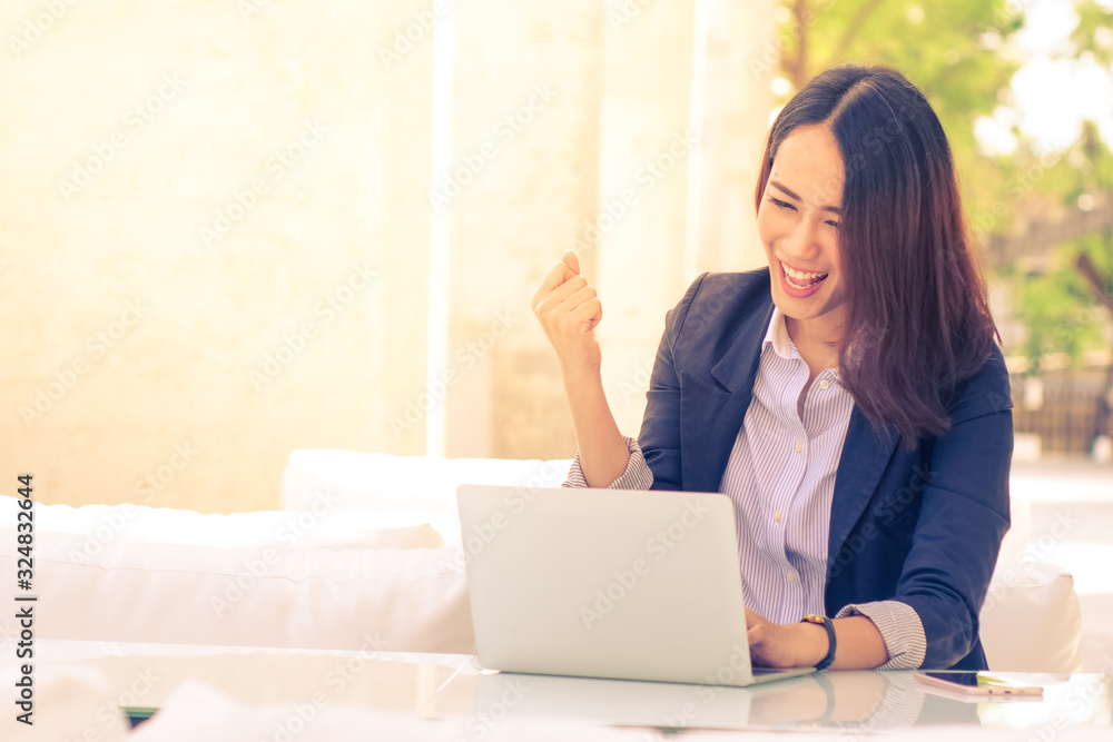 Asian business woman with laptop happy and smile concept success work
