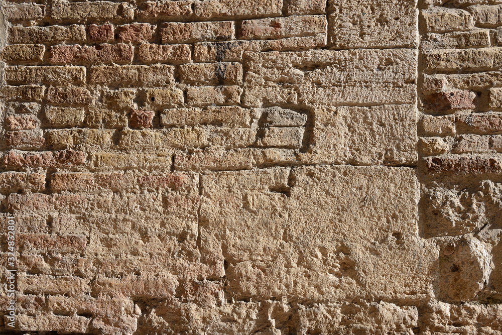 Old worn red brick wall with cracked concrete clay background texture. Old worn red brick wall with cracked concrete clay background texture.