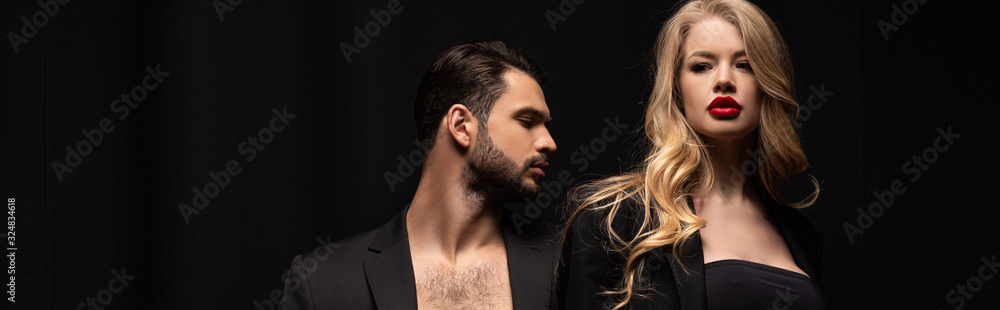 panoramic shot of attractive woman standing near bearded man isolated on black panoramic shot of attractive woman standing near bearded man isolated on black
