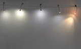 several lamps on a white wall. copy space