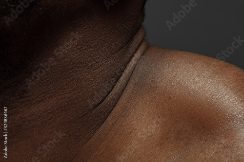 Neck. Detailed texture of human skin. Close up shot of young african-american male body. Skincare, bodycare, healthcare, hygiene and medicine concept. Looks beauty and well-kept. Dermatology.