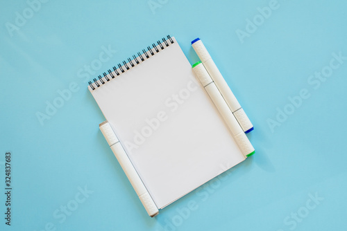  Notepad and sketch markers on a blue background