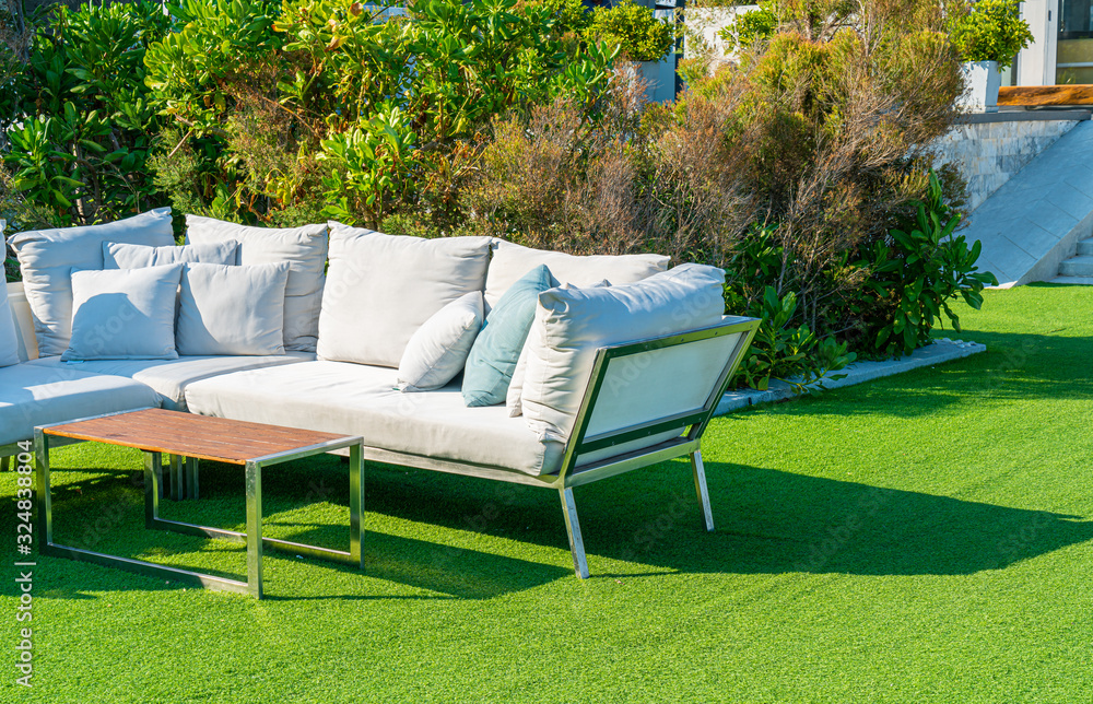 Obraz premium comfortable pillows on outdoor patio chair and table