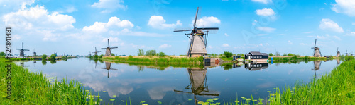 Panorama of the windmills and the reflection on water in Kinderdijk, a UNESCO World Heritage site in Rotterdam, Netherlands photo