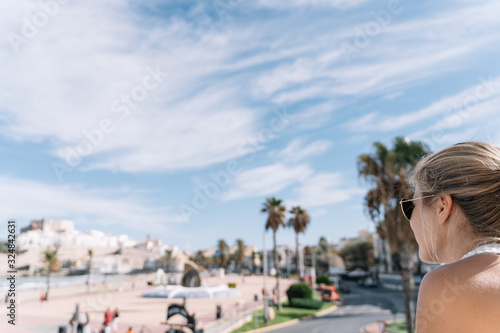 girl looking at peniscola city, in spain with copyspace