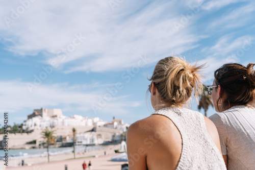 girl looking at peniscola city, in spain with copyspace photo