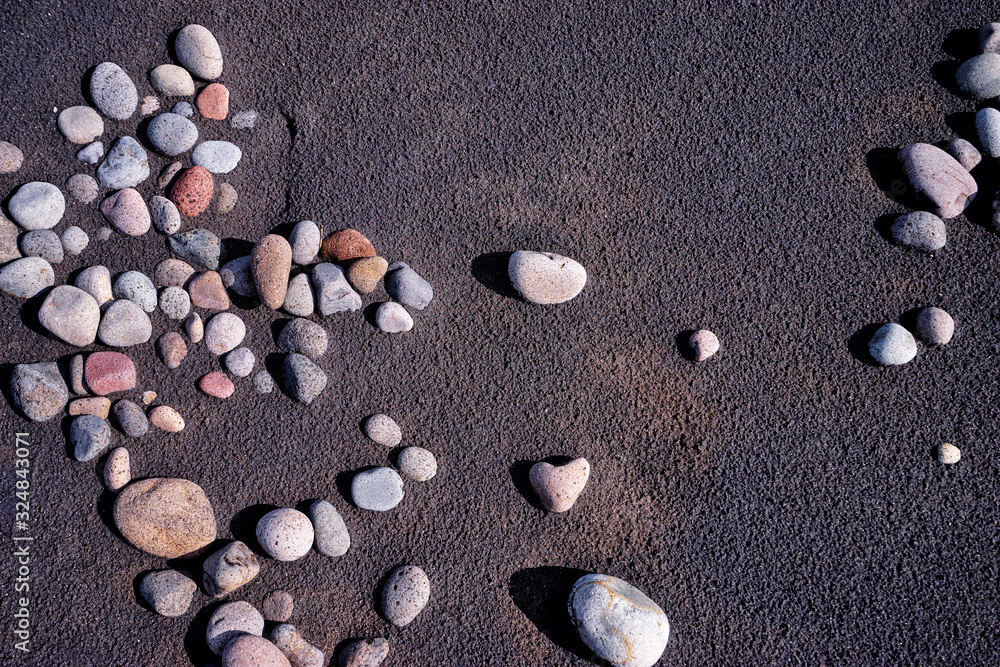 Black sand and pebble. Textured background. Black sand and pebble. Textured background.