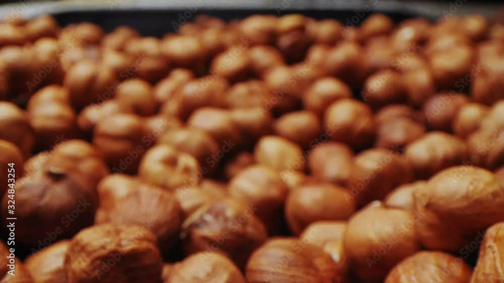 delicious hazelnuts pour onto heap in container macro delicious hazelnuts pour onto heap in container macro