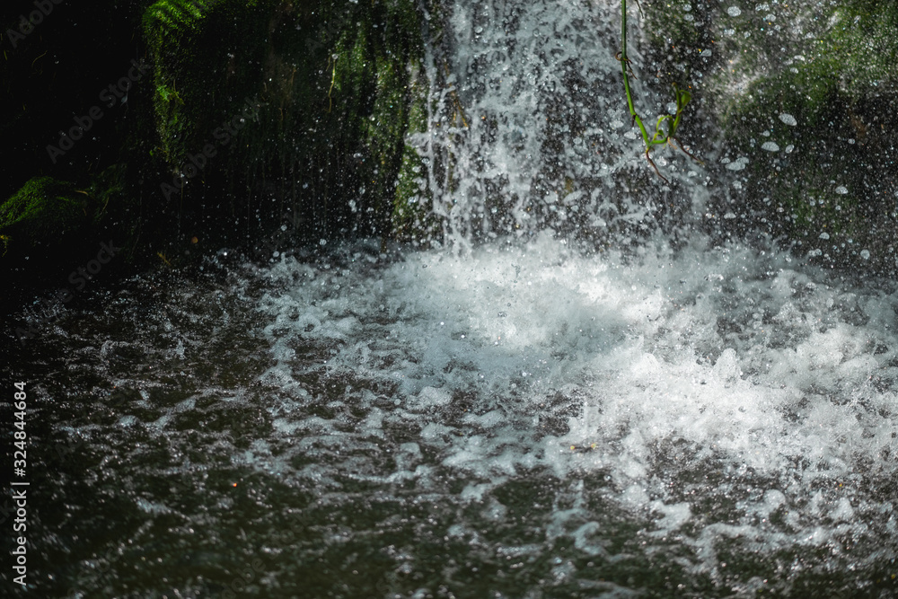 Close up of waterfall dropping into pond Close up of waterfall dropping into pond