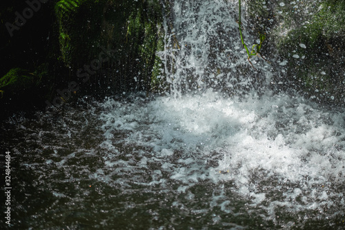 Close up of waterfall dropping into pond © bouybin