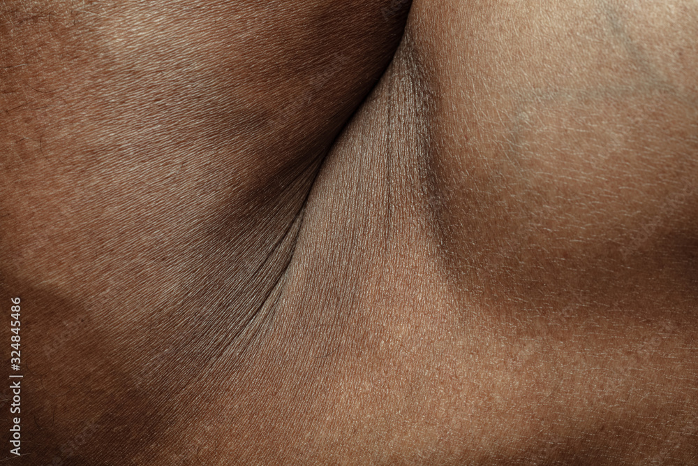 Naklejka premium Hand. Detailed texture of human skin. Close up shot of young african-american male body. Skincare, bodycare, healthcare, hygiene and medicine concept. Looks beauty and well-kept. Dermatology.