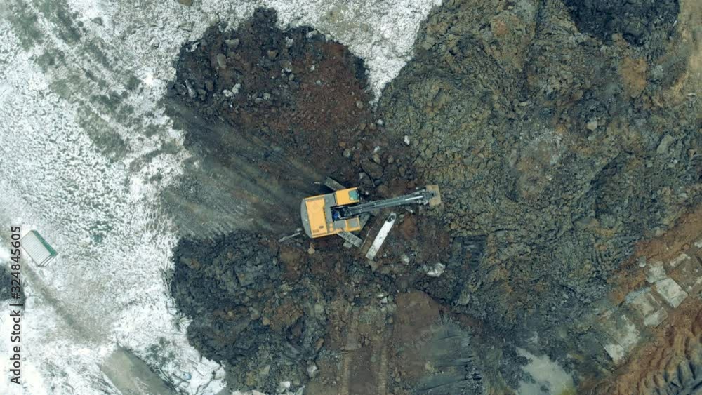 Machine moves stones with a bucket at a quarry. Machine moves stones with a bucket at a quarry.
