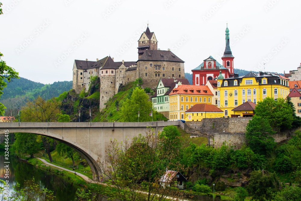 Fototapeta premium View of the bridge above Ohre river, the Castle and the Church of St. Wenceslaus in Loket, Czech Republic