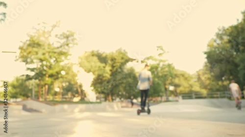 Wallpaper Mural A young guy is driving electric kick scooters at sport area Torontodigital.ca