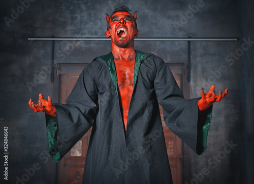 Canvas Print Terrible devil man screaming. Scary Halloween scene