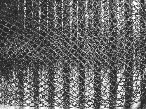 Distress vector texture of metal spring and fishing net on top of it. Black and white grunge background.