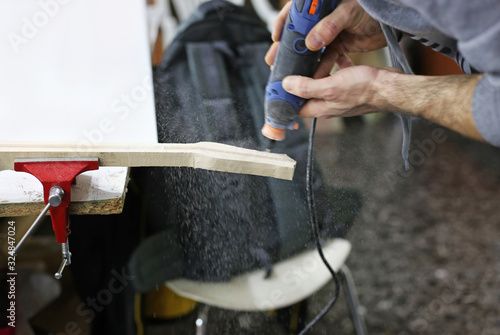 Fotografie instrument making - close up of a man making musical instruments - traditional g