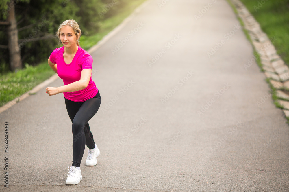beautiful young woman in sportswear in a summer park plays sports beautiful young woman in sportswear in a summer park plays sports