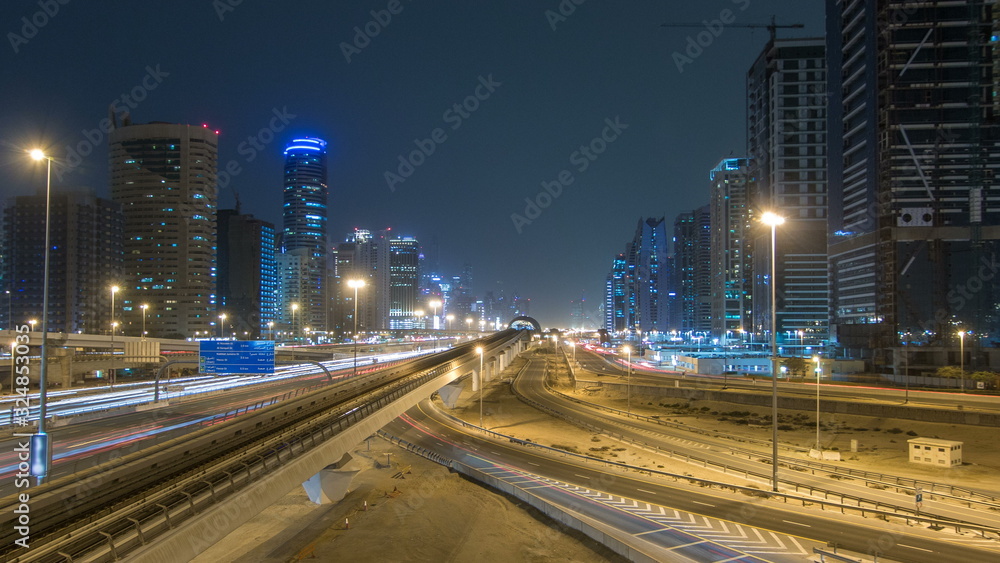 Sheikh Zayed road traffic night timelapse and Dubai Metro. Dubai, UAE.