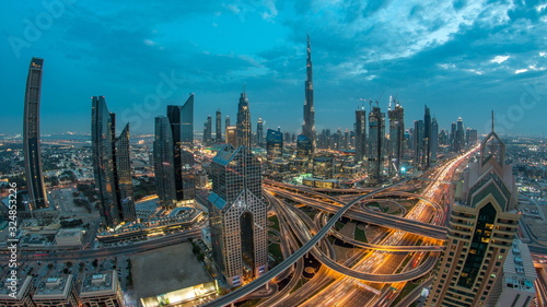 View on modern skyscrapers and busy evening highways day to night timelapse in luxury Dubai city, Dubai, United Arab Emirates