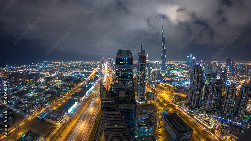 Beautiful panoramic skyline of Dubai night timelapse, United Arab Emirates. View of world famous skyscrapers.
