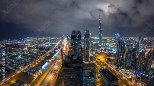 Beautiful panoramic skyline of Dubai night timelapse, United Arab Emirates. View of world famous skyscrapers.