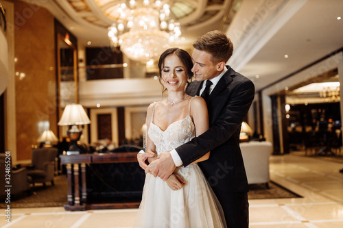 Happy and elegant couple on the hotel hall
