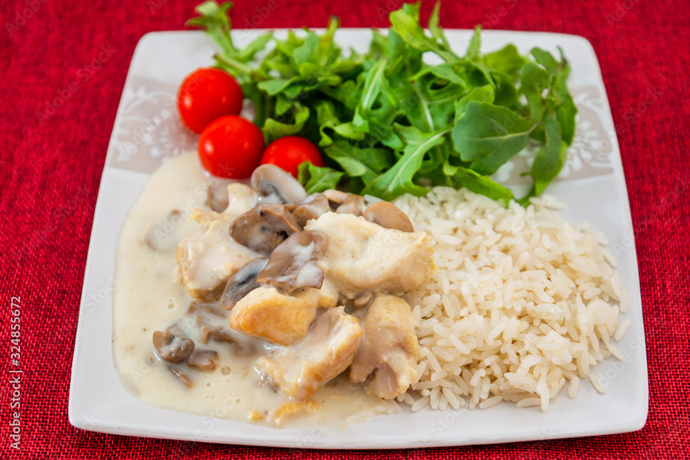 Pieces of chicken fillet cooked in a cream sauce with mushrooms and lemon juice, served with rice. Pieces of chicken fillet cooked in a cream sauce with mushrooms and lemon juice, served with rice.