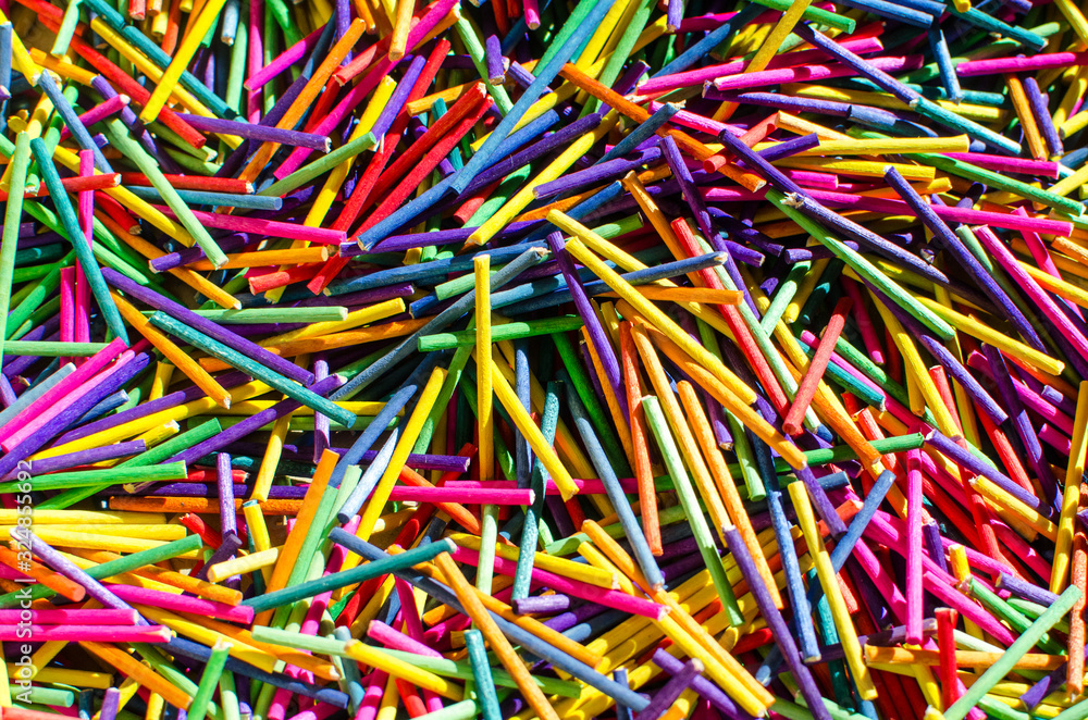 Background of colored sticks and tacks create an origami of cheerful and colorful colors.