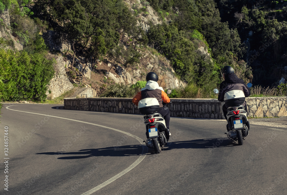 Two scooters riding Amalfi Coast roads, Italy Two scooters riding Amalfi Coast roads, Italy
