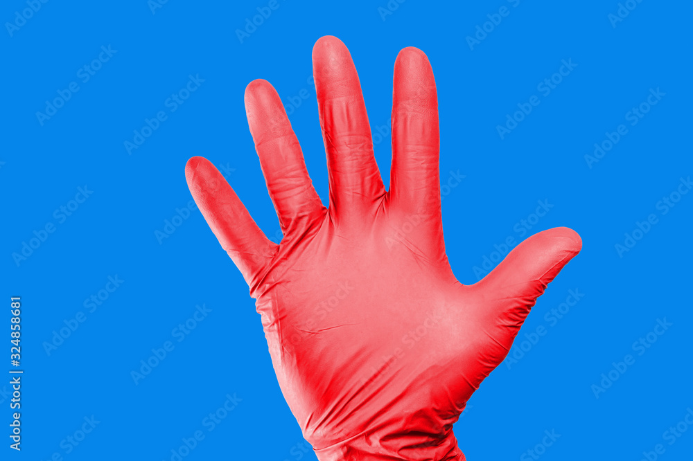 Hand stop gesture. Red latex glove isolated. Five fingers palm open hand. Higiene virus protection background. Hand stop gesture. Red latex glove isolated. Five fingers palm open hand. Higiene virus protection background.