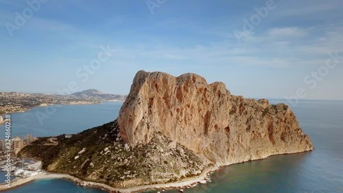 Aerial view big rock near Parque natural del Penon de Ifach in Calpe, symbol of Calpe town, 4k footage. Province of Alicante, Costa Blanca, Spain photo
