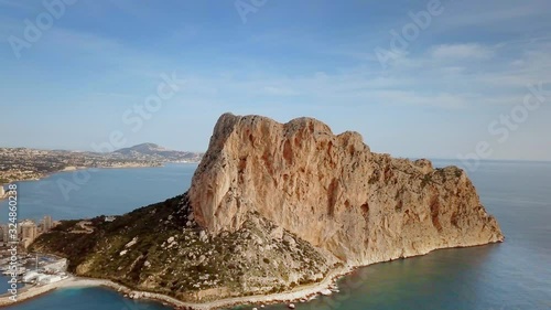 Aerial view big rock near Parque natural del Penon de Ifach in Calpe, symbol of Calpe town, 4k footage. Province of Alicante, Costa Blanca, Spain
