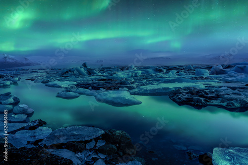 Cold iceland glacier jokulsarlon in the evening icebergs floating on the cold peaceful with northern lights aurora borealis