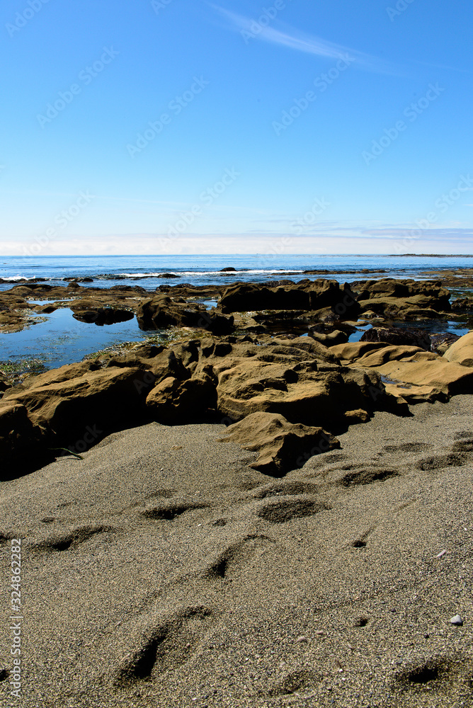Rocky coast and foot prints in the sand of the Pacific-Rim-Nationalpark coast, Vancouver Island, North-America, Canada, British Colombia, August 2015