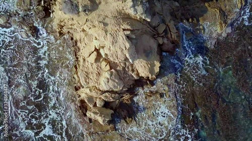 Waves are washing on stones and pebbles on the shore 4. Slow motion.