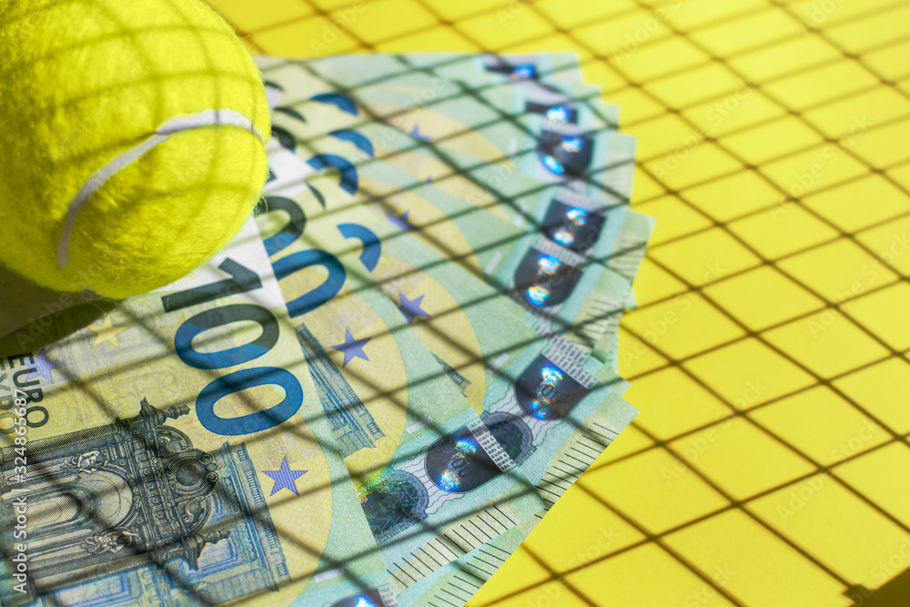 Tennis ball, euro banknotes and shadow from a racket on a yellow  background. Investment in sports, prize money and betting concept.  Selective focus. Close up Copy space. Photos | Adobe Stock