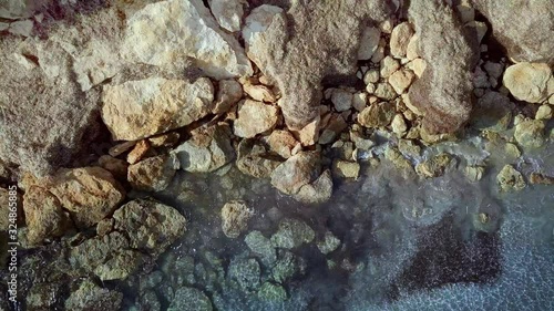 Waves are washing on stones and pebbles on the shore 4. Slow motion.