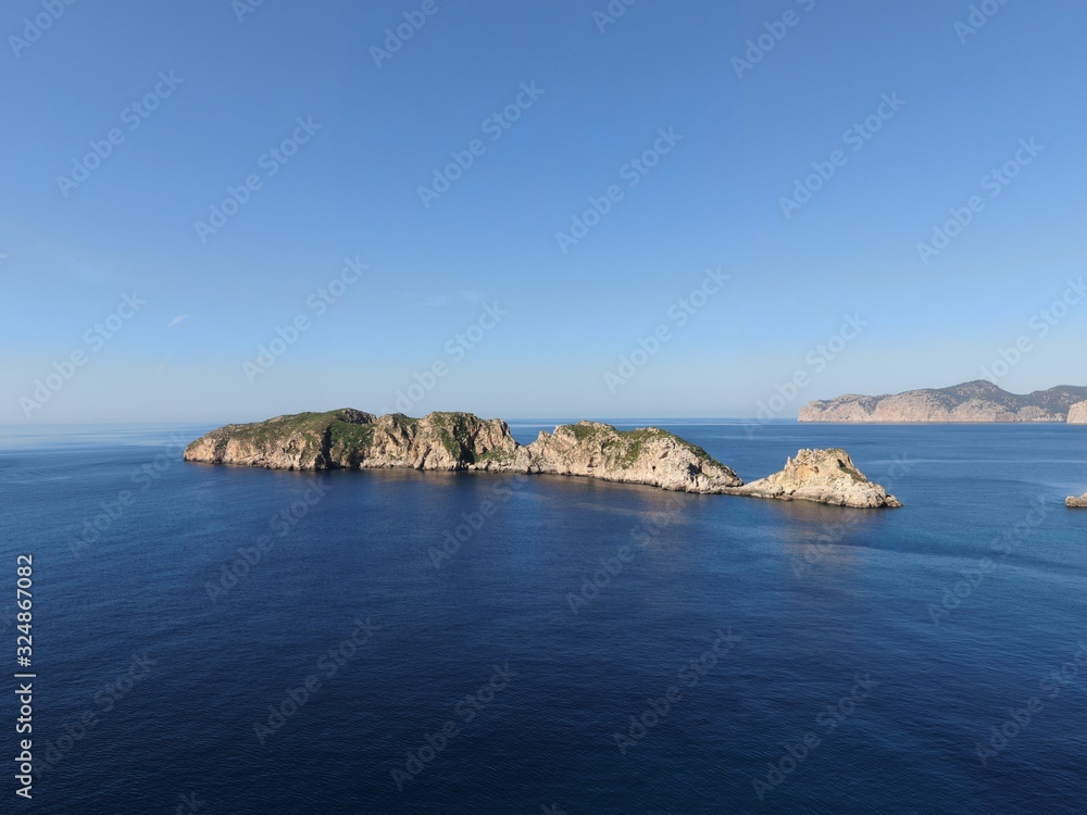 Seaview of the beach of the Mallorca coastline with turquoise waters and blue sky	