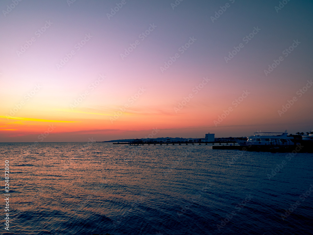 Beautiful dramatic sunset over the ocean. Sunrise on sea skyline. Waves over beach coast for wallpaper