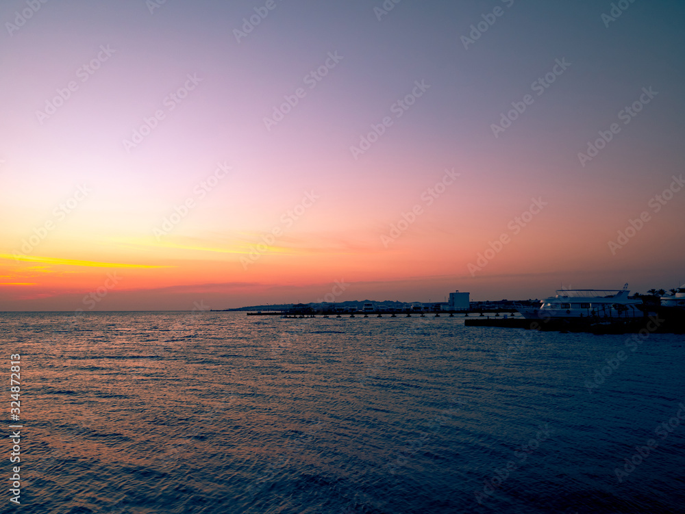 Beautiful dramatic sunset over the ocean. Sunrise on sea skyline. Waves over beach coast for wallpaper