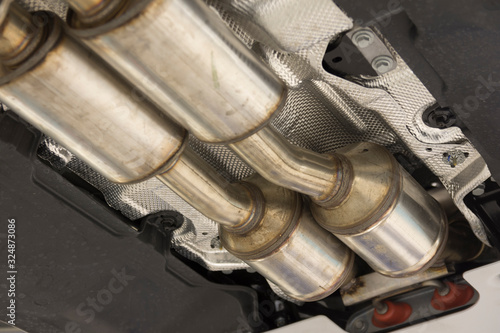 Obraz na płótnie Catalytic converter. Exhaust system of a modern car bottom view.