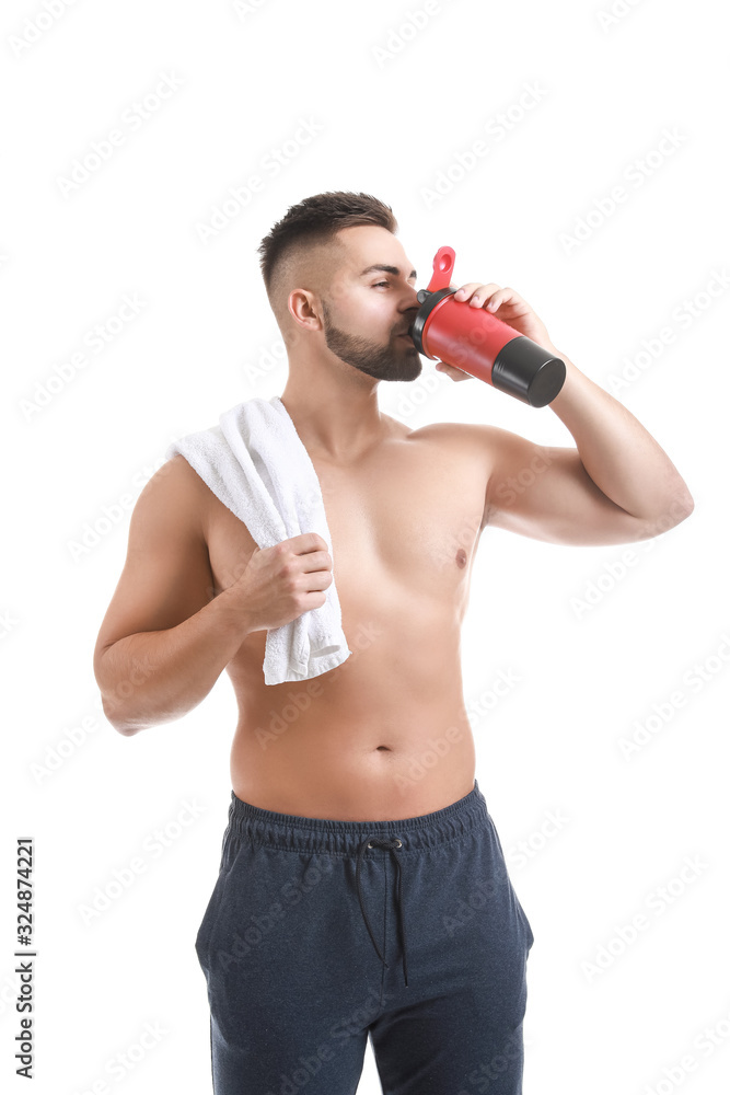 Naklejka premium Sporty man with protein shake on white background