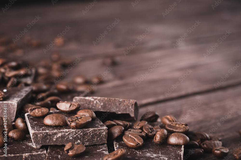 Dark chocolate with coffee beans on a dark wooden background. Sweet dessert. Dark chocolate with coffee beans on a dark wooden background. Sweet dessert.