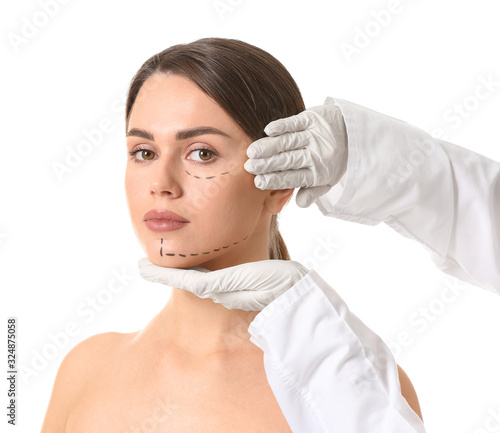 Plastic surgeon touching fa...