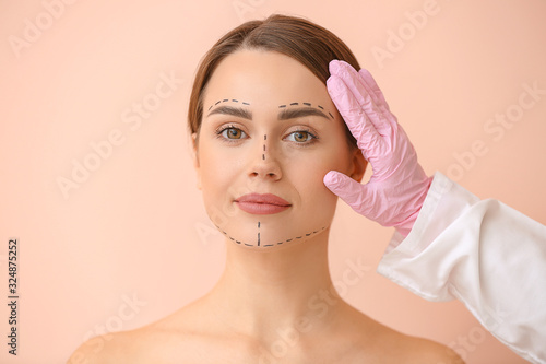 Plastic surgeon touching fa...