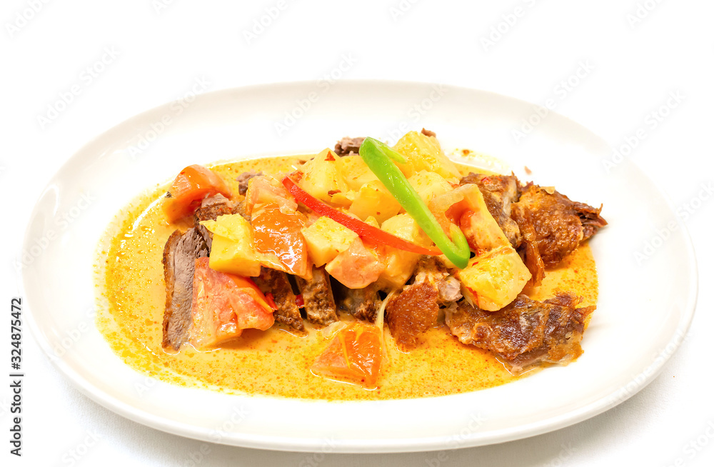 Kaeng Phed Ped Yang (Roasted Duck in Red Curry) , There is a pineapple, tomato and sliced bell pepper on top , Thai food. Kaeng Phed Ped Yang (Roasted Duck in Red Curry) , There is a pineapple, tomato and sliced bell pepper on top , Thai food.